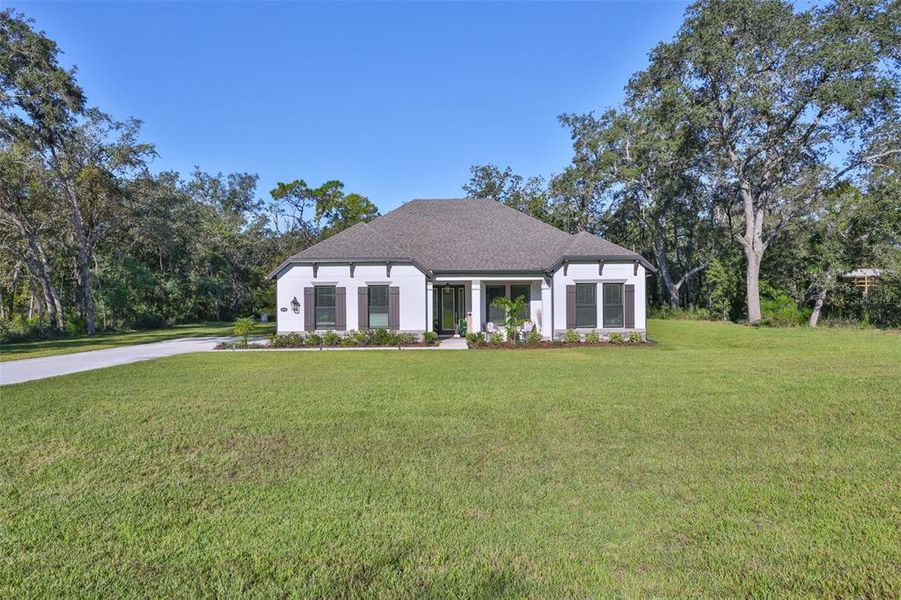 Front exterior of a new home in Bella Terra, Hudson, FL, highlighting curb appeal (Image 22).