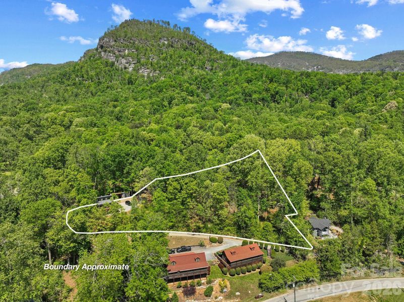 On 2 lots that add up to 1.01 acres, and walkable to Lake Lure & Chimney Rock conveniences.