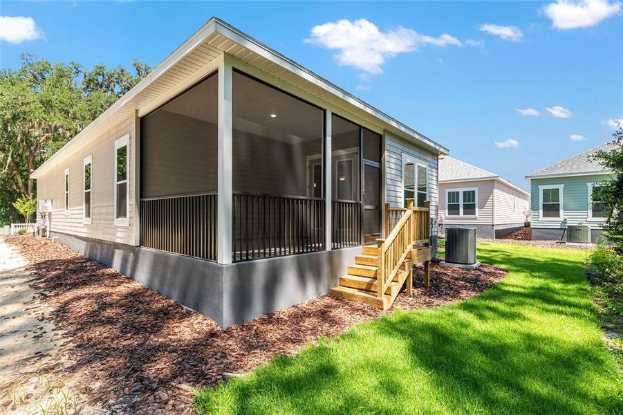 Front exterior of a new home in Fairway Pointe at West End, Newberry, FL, highlighting curb appeal (Image 23). Front exterior of a new home in Fairway Pointe at West End, Newberry, FL, highlighting curb appeal (Image 23).