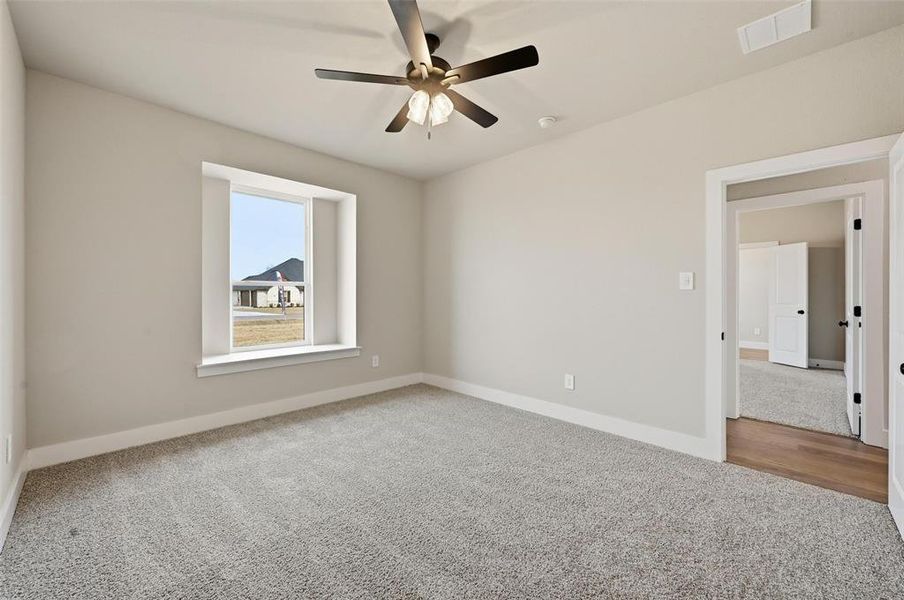 Empty room with carpet and ceiling fan