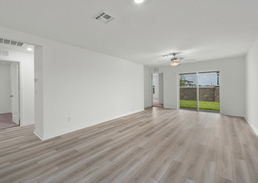 A spacious family room with sliding doors to the back patio