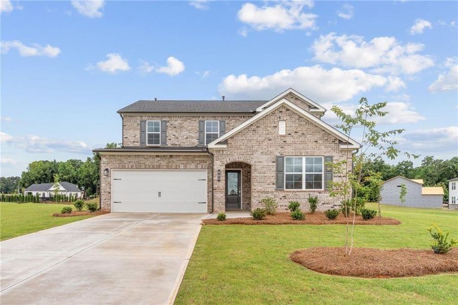 Front exterior of a new home in Walker Grove, McDonough, GA, highlighting curb appeal (Image 1). Front exterior of a new home in Walker Grove, McDonough, GA, highlighting curb appeal (Image 1).