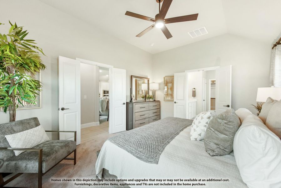 Master bedroom with ceiling fan, carpet flooring, and doors leading to ensuite bathroom and walk-in closet Master bedroom with ceiling fan, carpet flooring, and doors leading to ensuite bathroom and walk-in closet