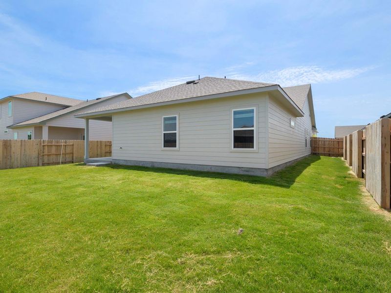 A pristine, well-maintained lawn embraces this property, offering ample space for outdoor enjoyment.