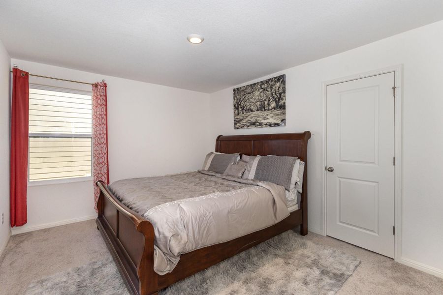 Bedroom featuring light carpet