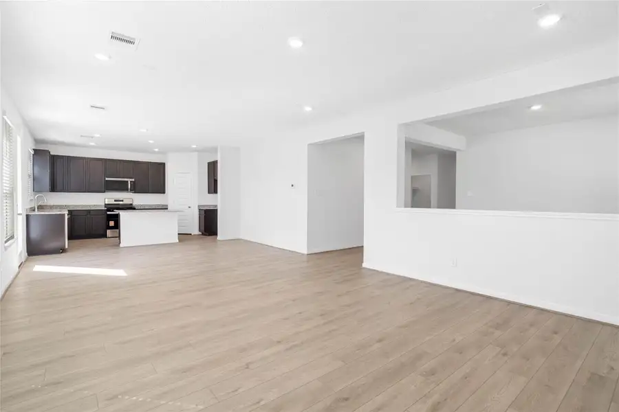 Stunning open-concept design seamlessly connecting the living, dining, and kitchen areas—perfect for both everyday living and entertaining!