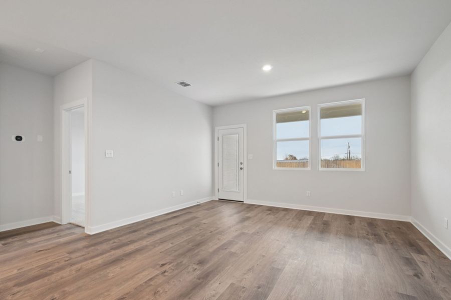 A room with a wood floor and white walls.