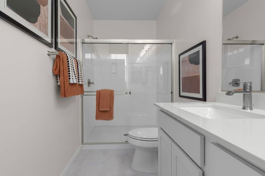 Upgraded shower with cultured marble surround at primary bath