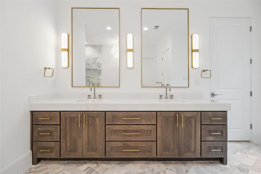 Custom Benedettini cabinetry, Quartzite countertops, Kallista Perfect under-mount oval sinks with Kallista One fixtures, and Alabaster sconces complete this elegant and serene primary retreat. Custom Benedettini cabinetry, Quartzite countertops, Kallista Perfect under-mount oval sinks with Kallista One fixtures, and Alabaster sconces complete this elegant and serene primary retreat.