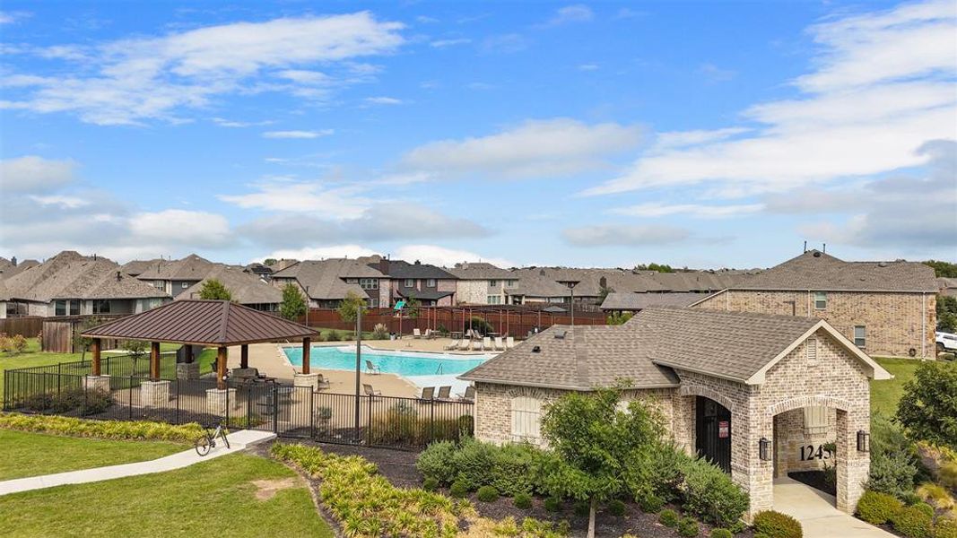 Community pool featuring a residential view, a patio area, and a gazebo