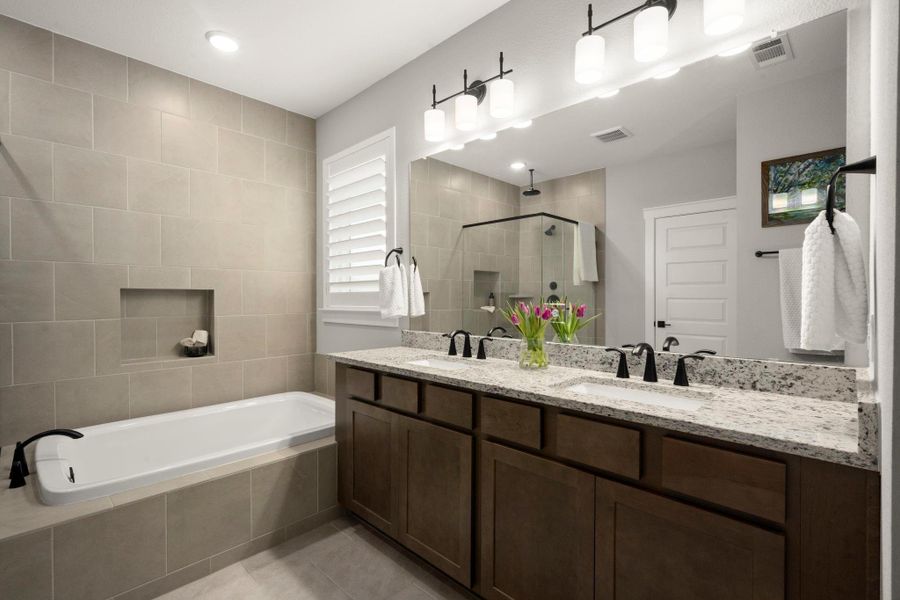 Granite countertops and double sinks are complemented by stained wood cabinetry. Granite countertops and double sinks are complemented by stained wood cabinetry.