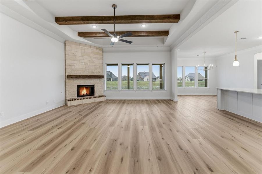 Spacious open-concept interior featuring light wood-finish flooring and numerous windows Spacious open-concept interior featuring light wood-finish flooring and numerous windows