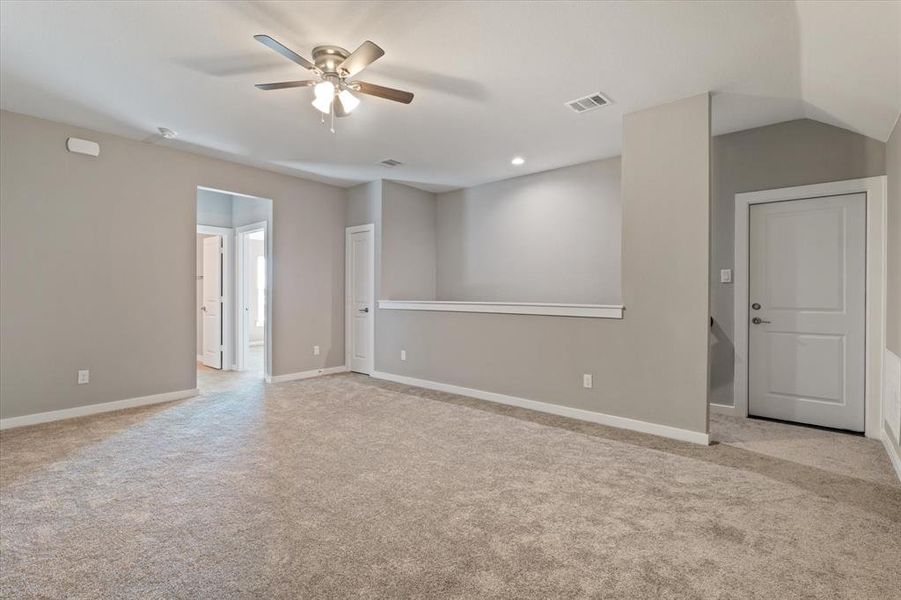 Unfurnished room with ceiling fan and light colored carpet Unfurnished room with ceiling fan and light colored carpet