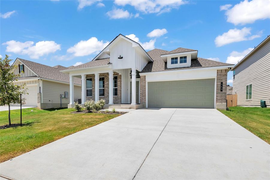 Modern farmhouse style home featuring a porch, board and batten siding, roof with shingles, a garage, and driveway Modern farmhouse style home featuring a porch, board and batten siding, roof with shingles, a garage, and driveway