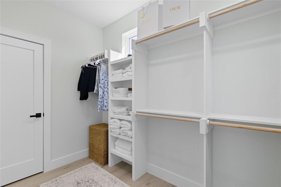 Spacious closet featuring light wood-type flooring
