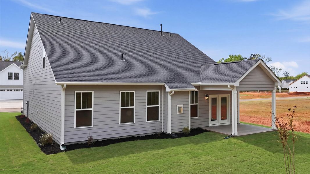 Elegant exterior with a rear covered porch—perfect for relaxing or entertaining outdoors at Pelham Crossing