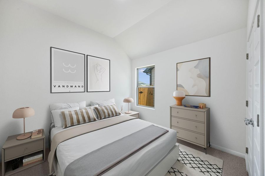 Bedroom featuring lofted ceiling and light colored carpet