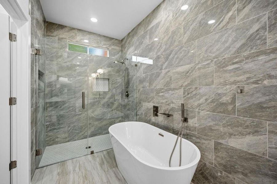 Modern bathroom featuring a freestanding soaking tub and a glass-enclosed shower Modern bathroom featuring a freestanding soaking tub and a glass-enclosed shower