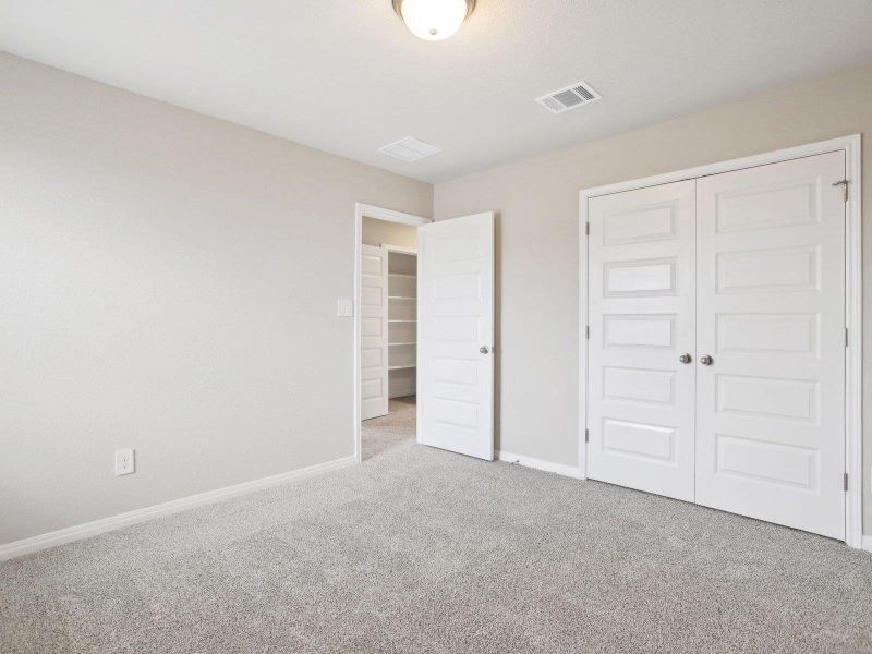 Unfurnished bedroom with carpet, baseboards, and a closet Unfurnished bedroom with carpet, baseboards, and a closet