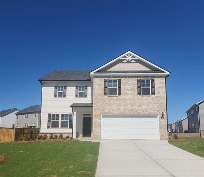 Front exterior of a new home in Cedar Ridge - Locust Grove Station, Locust Grove, GA, highlighting curb appeal (Image 1). Front exterior of a new home in Cedar Ridge - Locust Grove Station, Locust Grove, GA, highlighting curb appeal (Image 1).