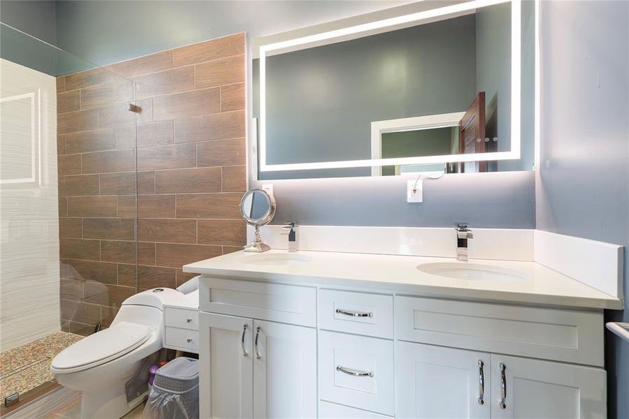 Full bath featuring walk in shower and double vanity Full bath featuring walk in shower and double vanity