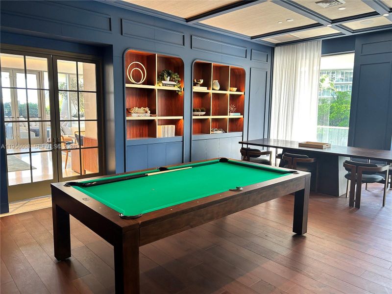 Elegant resident lounge featuring billiards table, custom millwork, and refined social space for entertaining and relaxing at Mr. C Residences Coconut Grove.