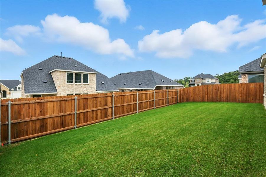 Fenced backyard featuring a residential view Fenced backyard featuring a residential view