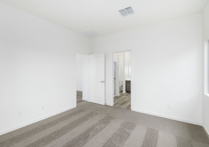 The master bedroom seamlessly connects to the bathroom and walk-in closet.