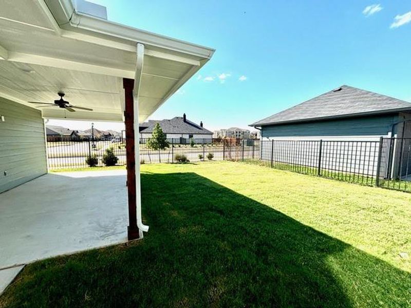 View of yard featuring ceiling fan and a patio area