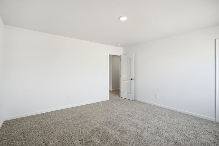 A room with a carpet and a door. A room with a carpet and a door.