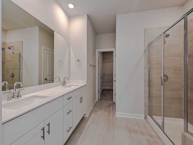 The primary bath offers dual vanity sinks and walk-in shower.