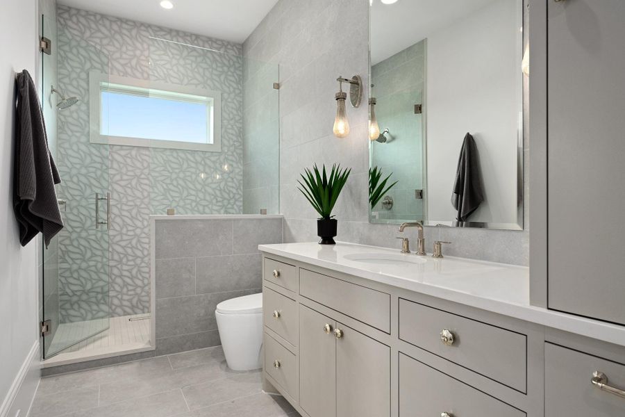 A well-appointed bathroom with a spacious walk-in shower and elegant dual vanity.