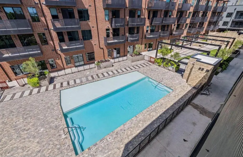 A refreshing swimming pool sits nestled within a paved courtyard overlooked by private balconies. A refreshing swimming pool sits nestled within a paved courtyard overlooked by private balconies.