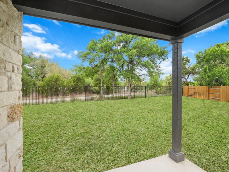 Fenced backyard featuring a patio area & Greenbelt view