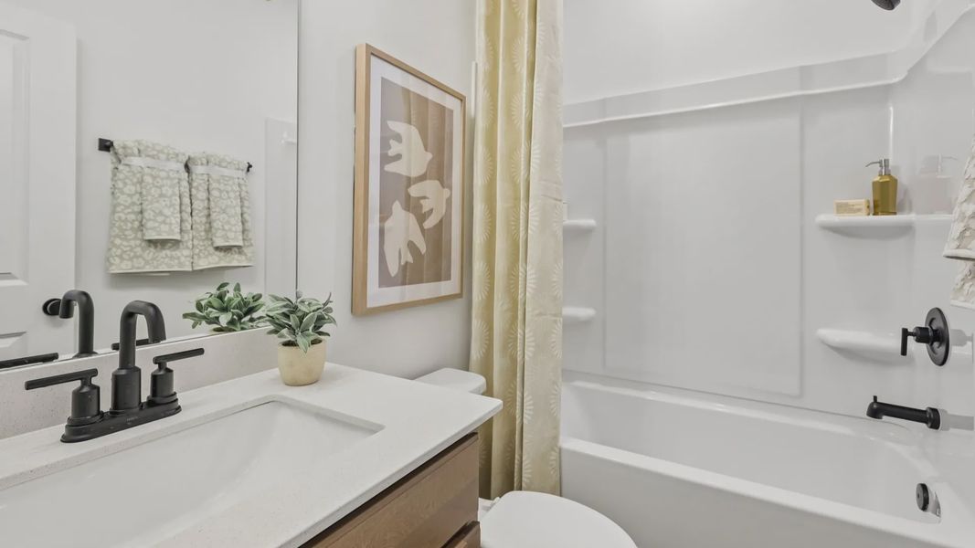 Bathroom with vanity, toilet, and shower