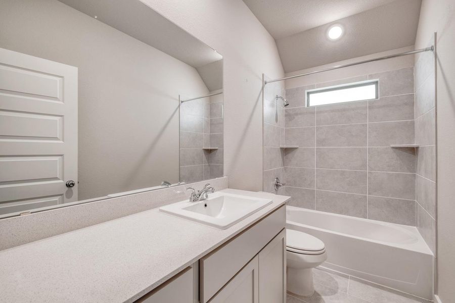 A well-appointed bathroom features a single vanity and a tiled shower-tub combination, ready for everyday use. A well-appointed bathroom features a single vanity and a tiled shower-tub combination, ready for everyday use.