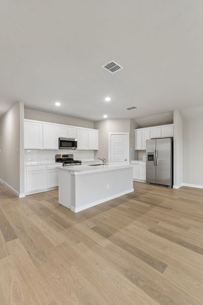 Kitchen in the Emmy II home plan by Trophy Signature Homes - REPRESENTATIVE PHOTO