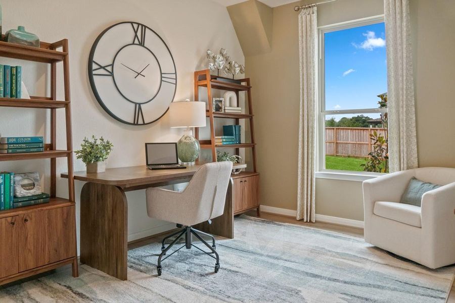 The Den is a versatile and additional living space that can be used as a home office, hobby or play room. It features vinyl plank flooring, high ceilings, large window, and neutral paint.