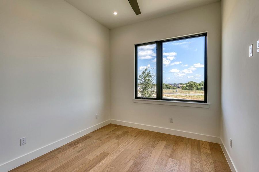 Rich hardwood flooring complements the crisp white walls and framed views of the outdoors. Rich hardwood flooring complements the crisp white walls and framed views of the outdoors.