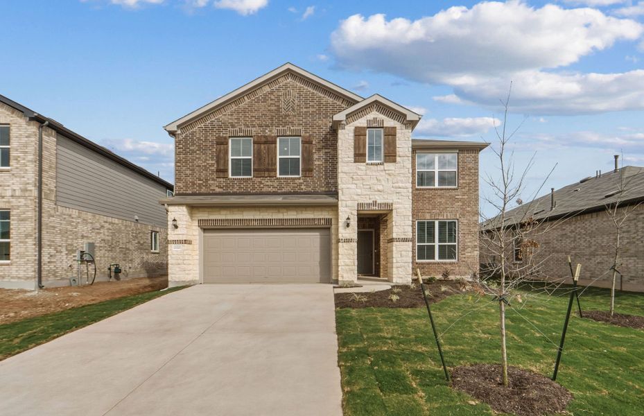 Front exterior of a new home in Lagos, Manor, TX, highlighting curb appeal (Image 21).