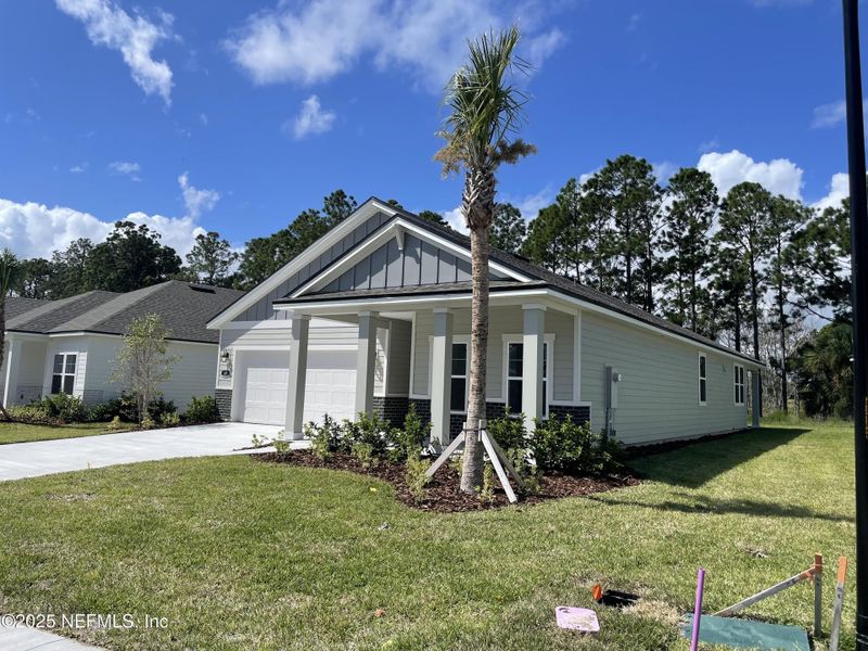 Front exterior of a new home in The Magnolia Series at Reserve East, Flagler Beach, FL, highlighting curb appeal (Image 19).