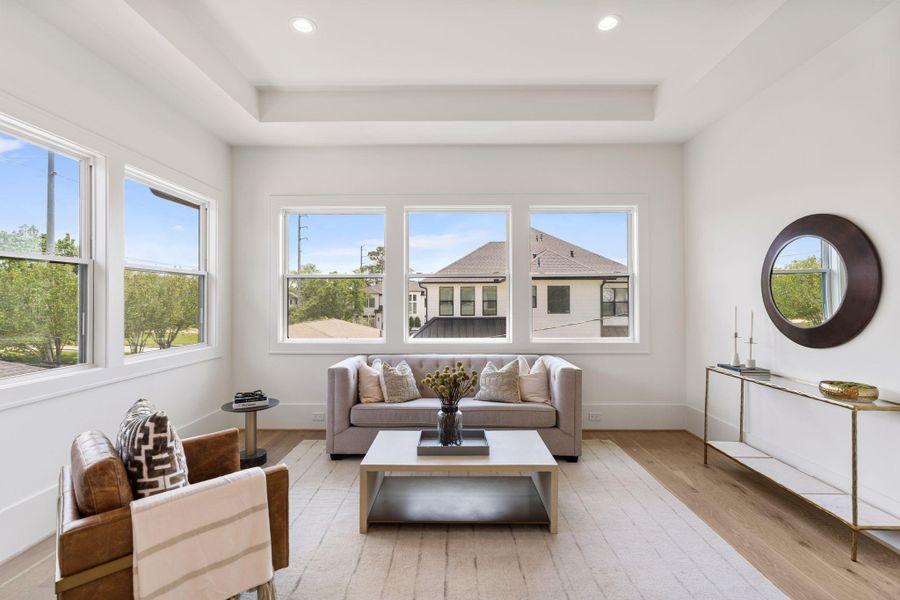 A dedicated sitting area within the primary suite provides additional flexibility, ideal for relaxing, reading, or creating a private lounge.