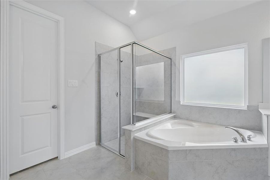 Full bathroom with a garden tub and a stall shower Full bathroom with a garden tub and a stall shower
