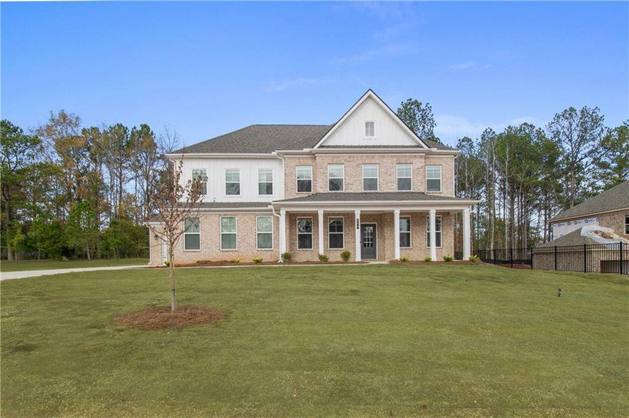 Front exterior of a new home in Cambria at Traditions, Hampton, GA, highlighting curb appeal (Image 1). Front exterior of a new home in Cambria at Traditions, Hampton, GA, highlighting curb appeal (Image 1).