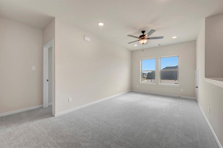 Empty room featuring light colored carpet, a ceiling fan, and recessed lighting