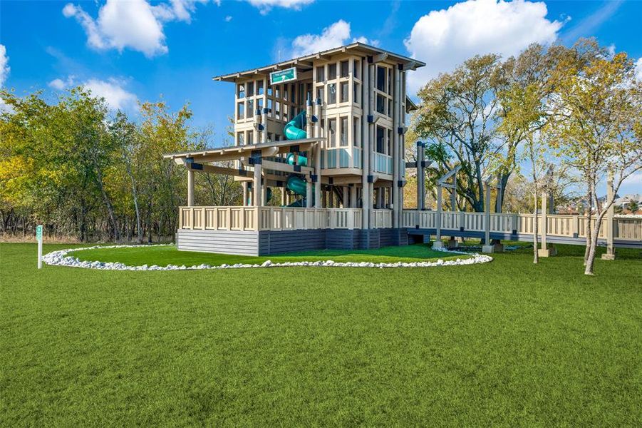 One of Sandbrock Ranch's most iconic amenities, the community Treehouse offers a unique gathering space for residents of all ages. Overlooking scenic green space, this multi-level play structure features slides, climbing areas, and elevated viewing platforms that encourage outdoor adventure and imagination. It's just one of the many resort-style amenities that make Sandbrock Ranch one of North Texas' most sought-after master-planned communities. One of Sandbrock Ranch's most iconic amenities, the community Treehouse offers a unique gathering space for residents of all ages. Overlooking scenic green space, this multi-level play structure features slides, climbing areas, and elevated viewing platforms that encourage outdoor adventure and imagination. It's just one of the many resort-style amenities that make Sandbrock Ranch one of North Texas' most sought-after master-planned communities.