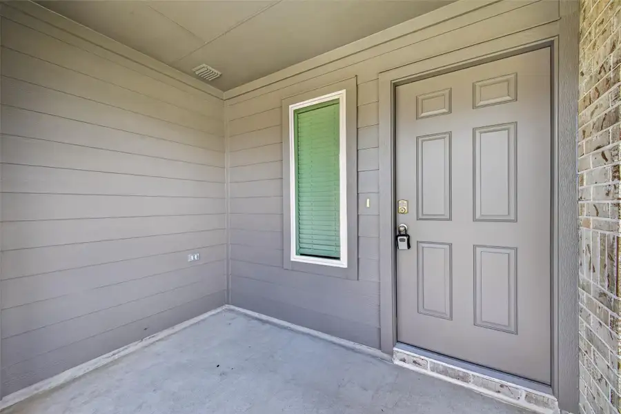Exterior details and patio area of a home in Breckenridge Forest, Spring (Image 4).