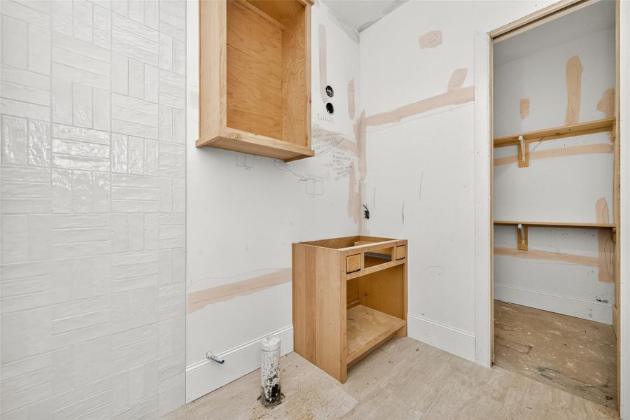 Full bath in bedroom four with view of closet entry.