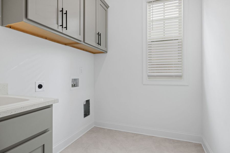 Spacious laundry room with elegant cabinets