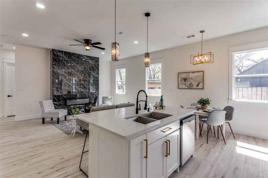 Kitchen with visible vents, light wood-style flooring, a sink, recessed lighting, and dishwasher